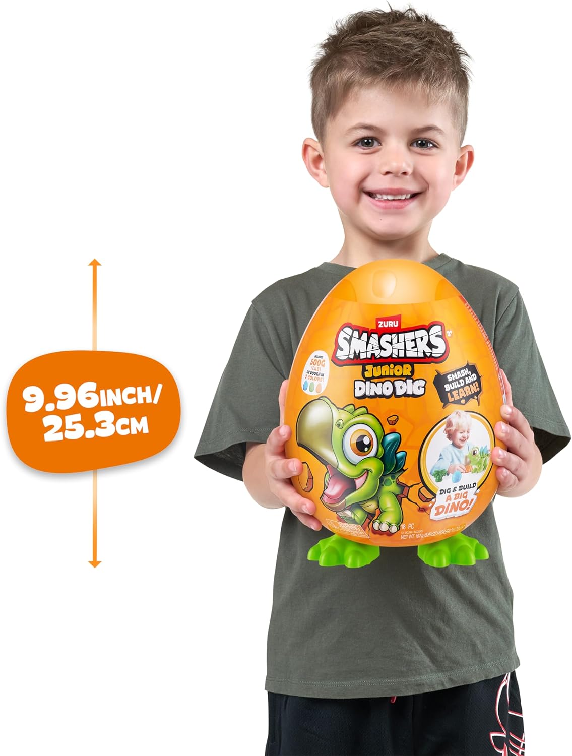 Preschool child smashing open the large green ZURU Smashers Jr dinosaur egg on floor