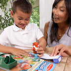 Toddler hand independent use of the chunky Pepper the Fox sticker stamper on matching activity book page