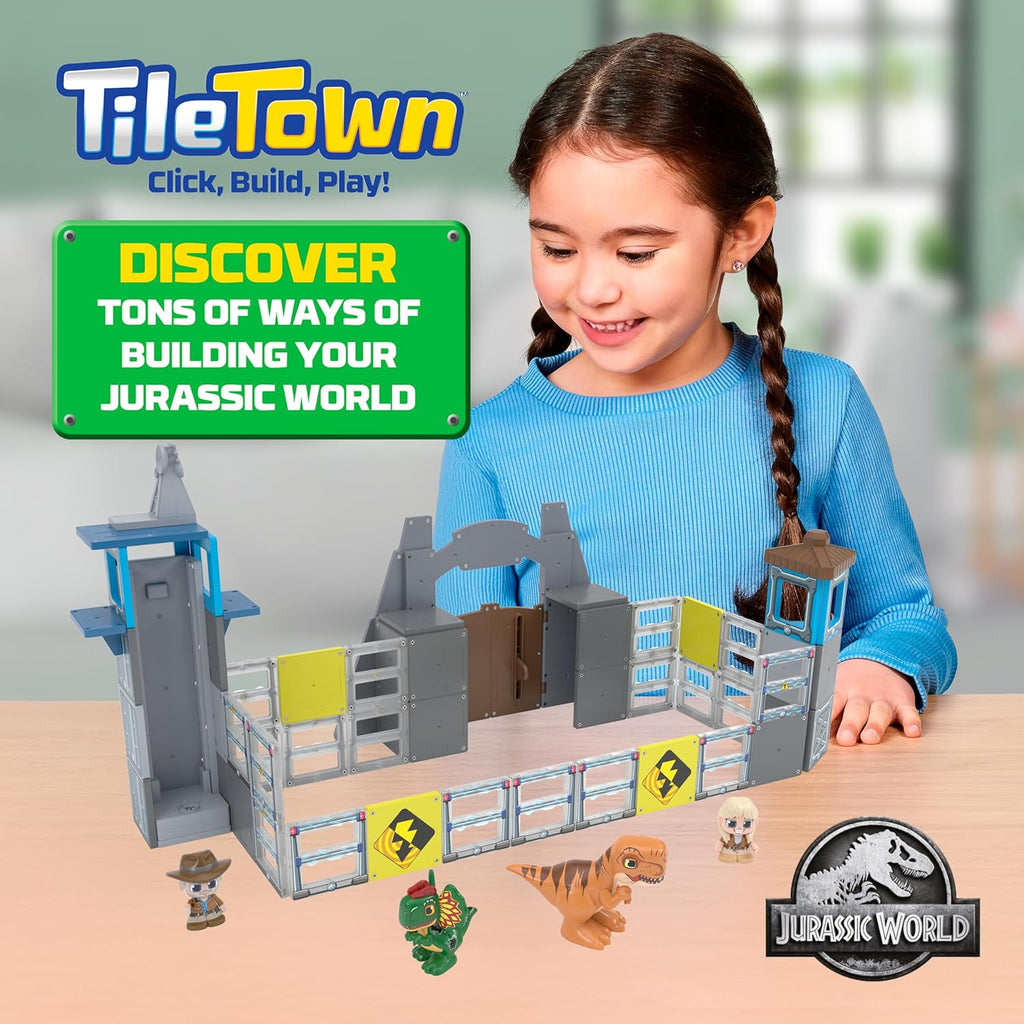 A child using the manual magnetic elevator tile to raise a character figure up the Jurassic World gate tower