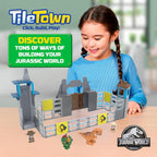 A child using the manual magnetic elevator tile to raise a character figure up the Jurassic World gate tower