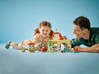 The DUPLO child figure riding the red push along toy tractor accessory piece across the farm