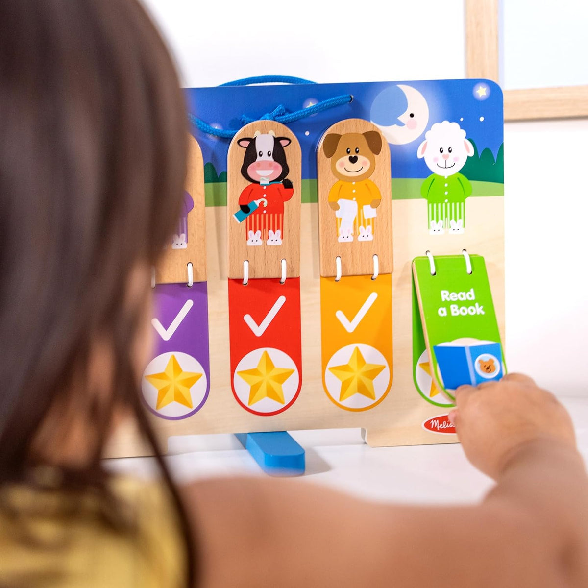 The nighttime routine side of the Melissa and Doug wooden chart showing bedtime tasks and fold out stand